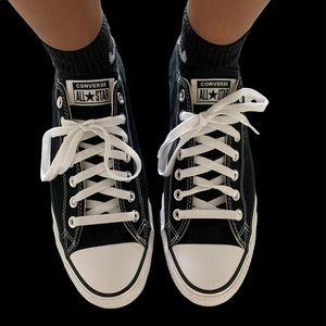 Black low top converse with white laces